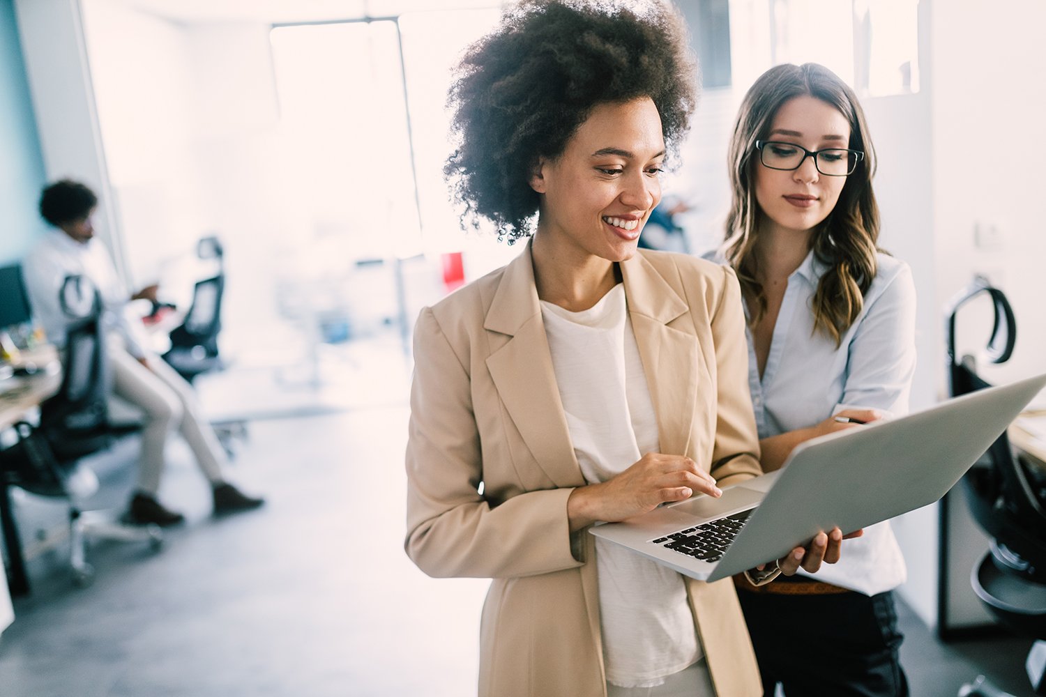 Learning People | 2 women professionals in office with laptop